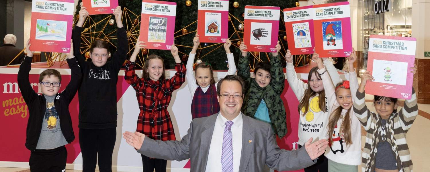 Mike with his 2023 Christmas card competition winners for the prize presentation at Merry Hill