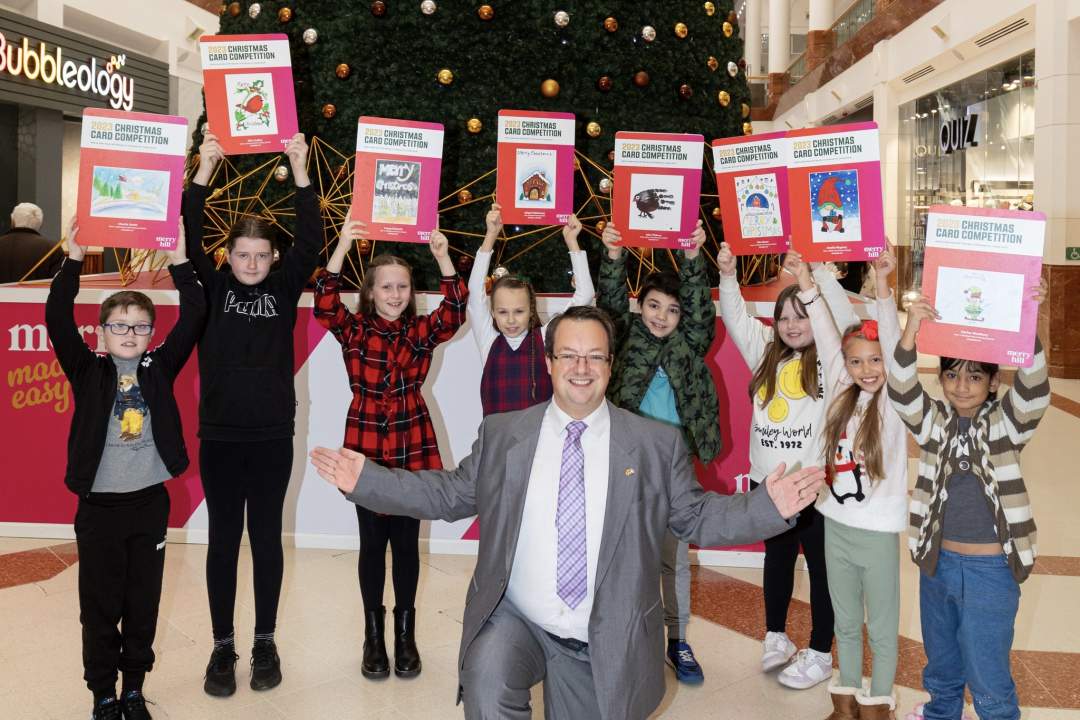 Mike with his 2023 Christmas card competition winners for the prize presentation at Merry Hill